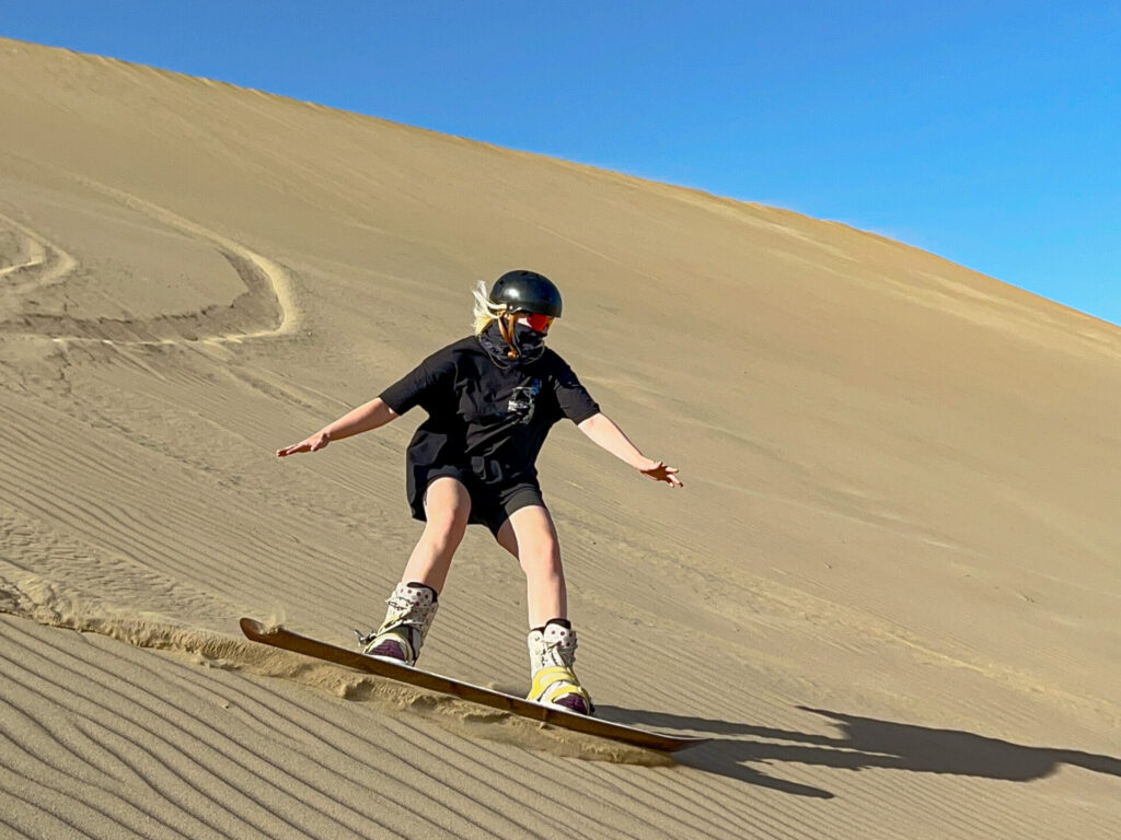 Sand surfing in Huacachina, Peru