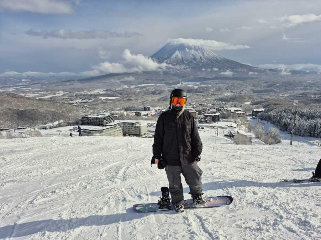 female snowboarder in Niseko with a view of mount yotei in the background