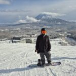 female snowboarder in Niseko with a view of mount yotei in the background