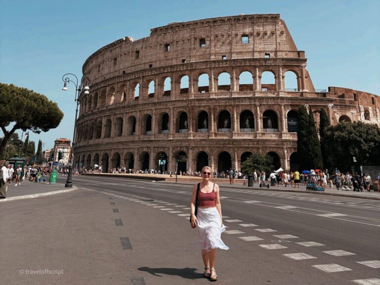 bell in front of colosseum
